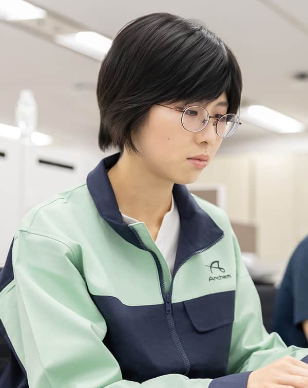 作業着を着た女性社員が業務に取り組む様子